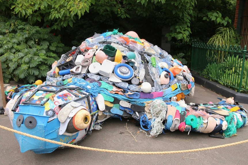 A turtle sculpture made from rubbish from the ocean, including shoes, buoys and ropes.