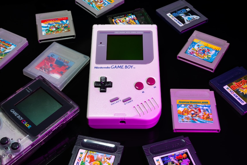 A photo of a Game Boy surrounded by games.