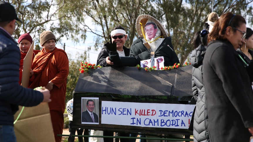 Protesters with a mock coffin with "Hun Sen killed democracy in Cambodia" on the side. 
