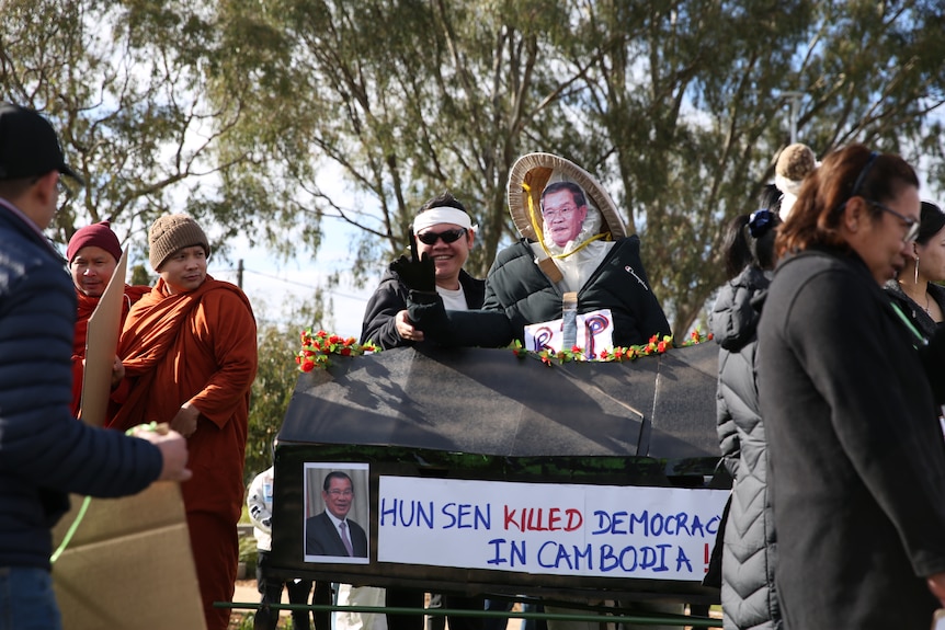 Protesters with a mock coffin with "Hun Sen killed democracy in Cambodia" on the side. 