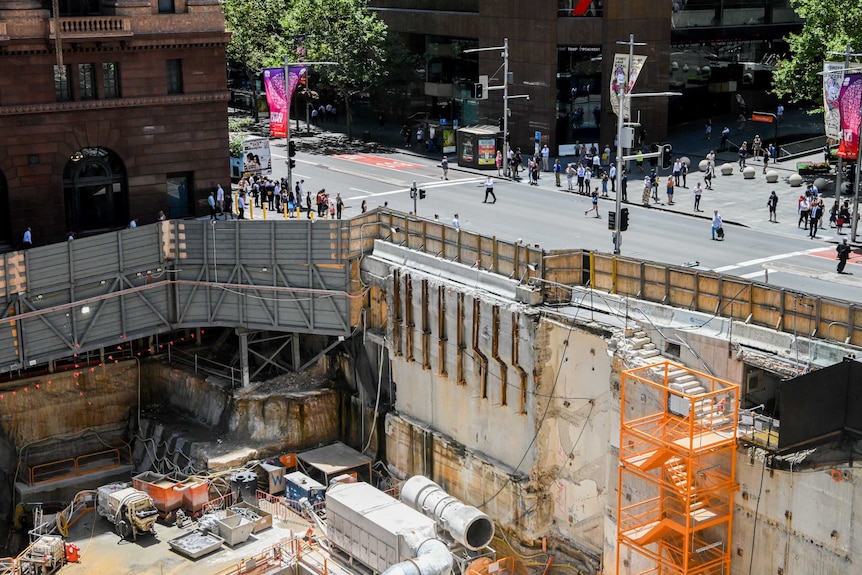 A huge hole in the ground in a cityscape