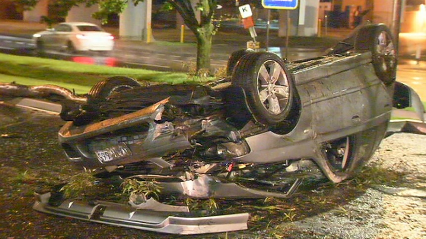 A car sits on its roof after it flipped and crashed in Melbourne.