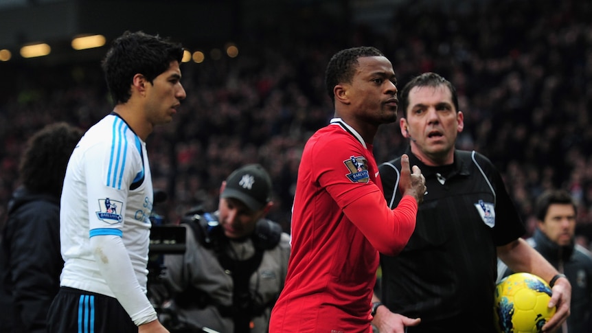 Walking away a winner ... United skipper Patrice Evra leaves Luis Suarez and Liverpool in his wake.