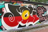 A mural painted in graffiti style on a wall. 