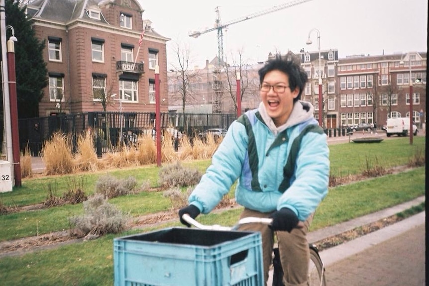 Australian student Christopher riding a bike on an overseas exchange study trip in Amsterdam