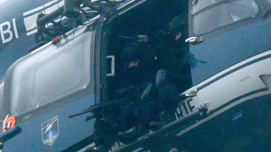 Close up of French forces onboard helicopter above where Charlie Hebdo suspects believed to be holding hostages