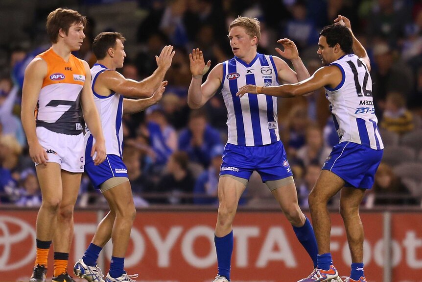 Jack Ziebell of the Kangaroos celebrates after kicking a goal against Richmond at Docklands.