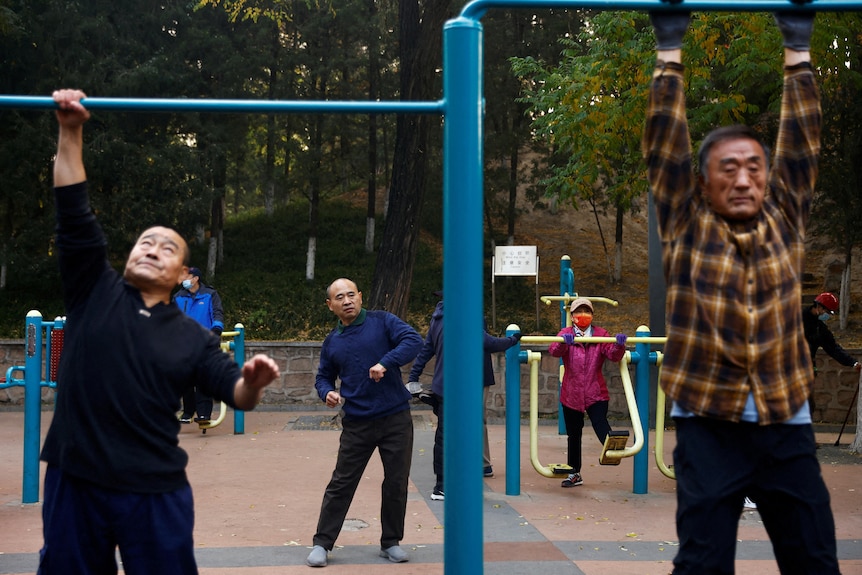 Elderly people exercise in the morning at a park.