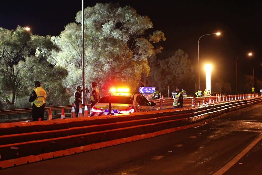 Cops at night on a bridge checkpoint