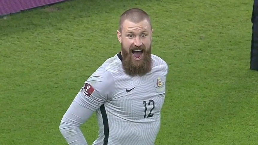 Andrew Redmayne poses with a huge smile after winning the penalty shoot out for the Socceroos in 2022