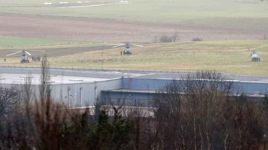 French forces stand next to a helicopter where Charlie Hebdo suspects believed to have taken hostages