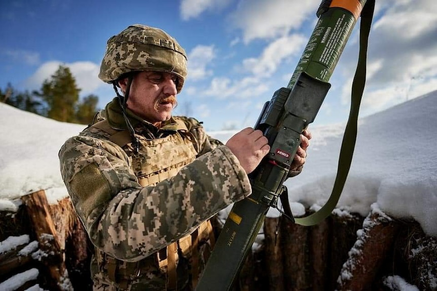 A Ukrainian service member learns to use a M141 Bunker Defeat Munition weapon.