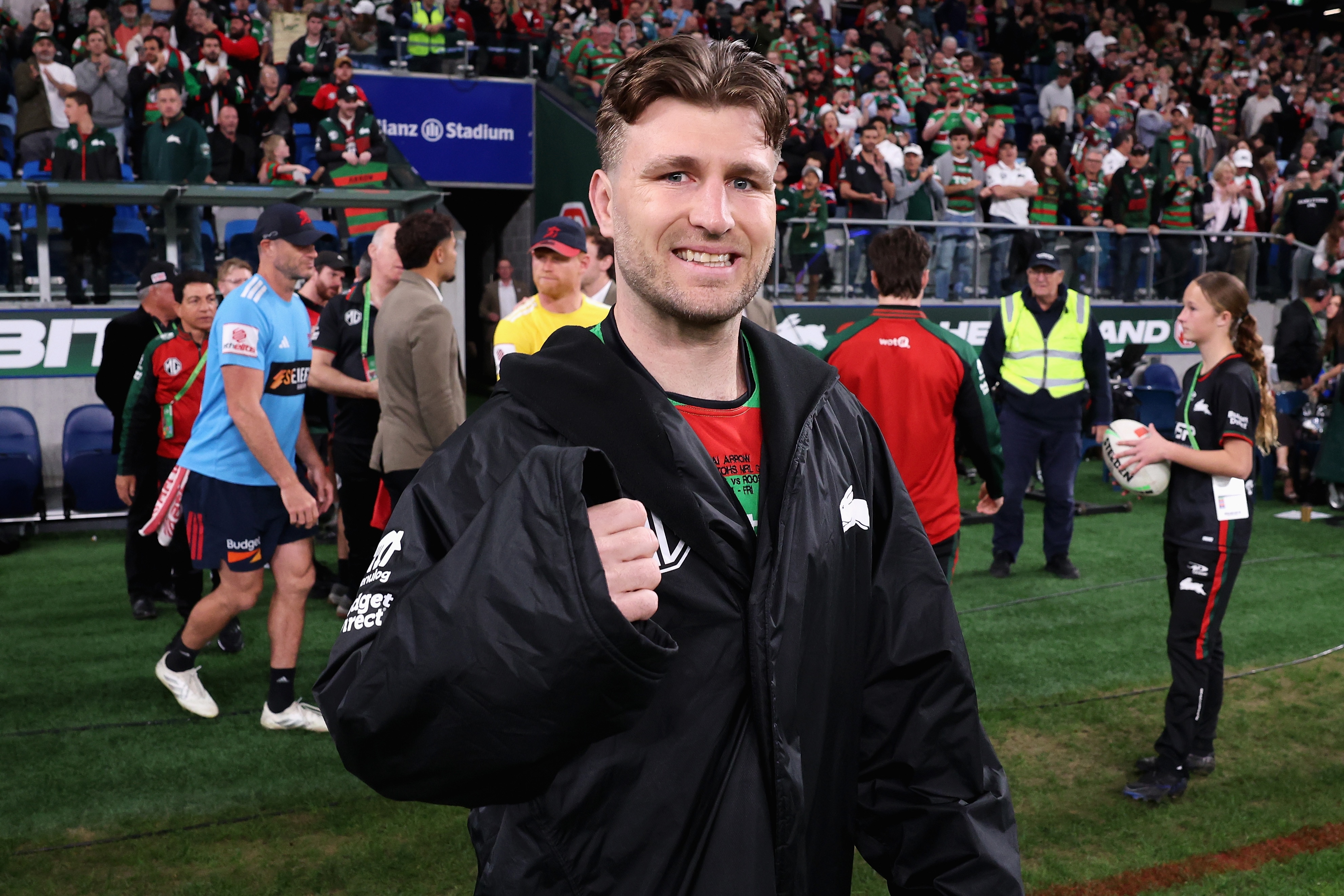 Jai Arrow smiles as he walks on the field 