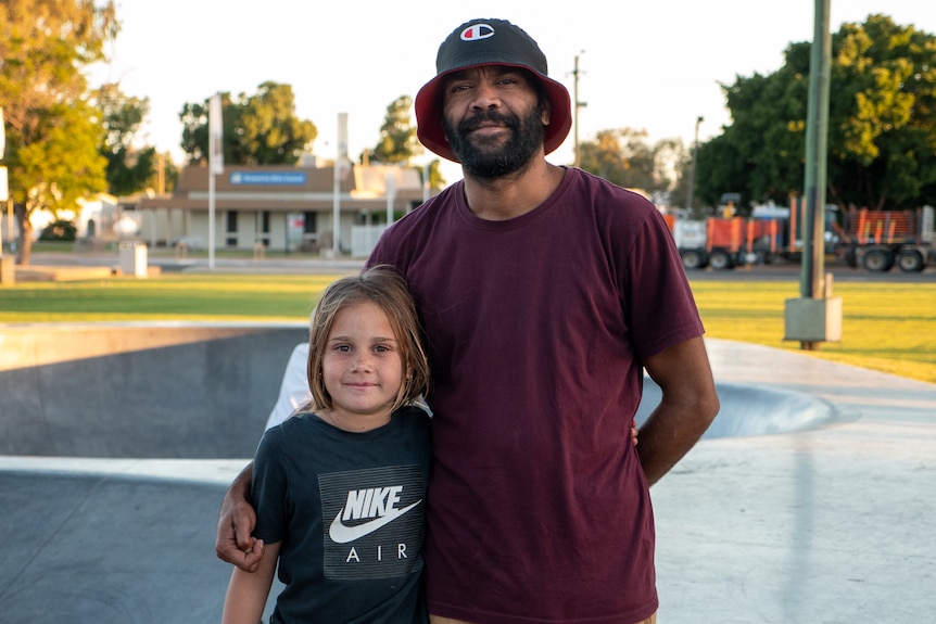 A father and his daughter stand together at the skate park in Brewarrina