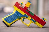 A blue, yellow, red and green covering for a pistol.