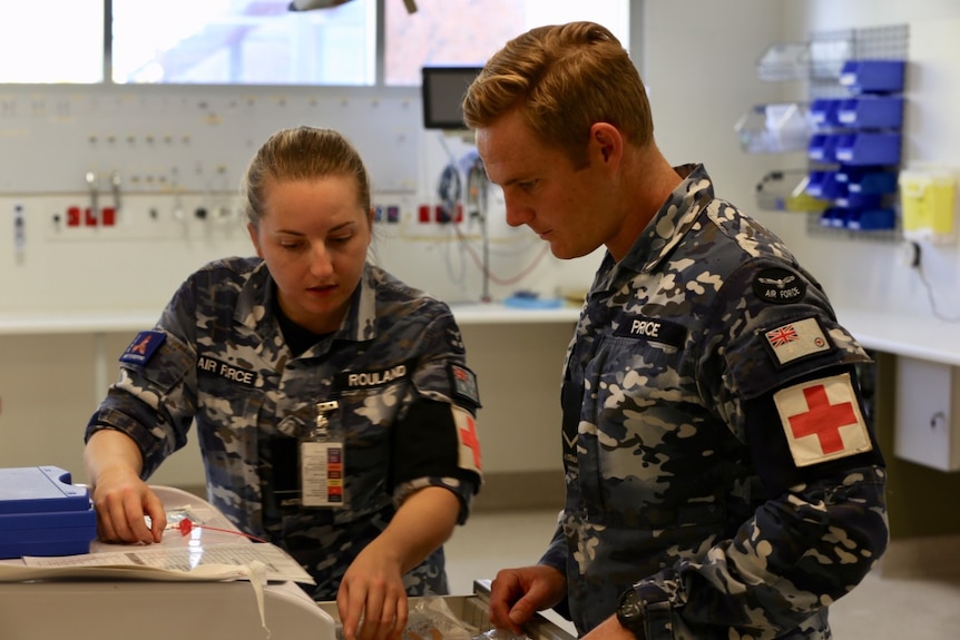 Officer Emma Rouland and Medic Lloyd Price at work in the Burnie hospital