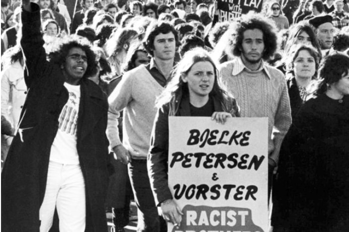 A black-and-white shot showing Indigenous and white people protesting.