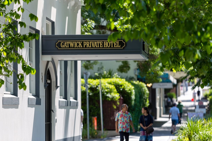 Passers-by walk beneath the front entrance of the Gatwick Private Hotel in Fitzroy Street St Kilda, November 19, 2018.