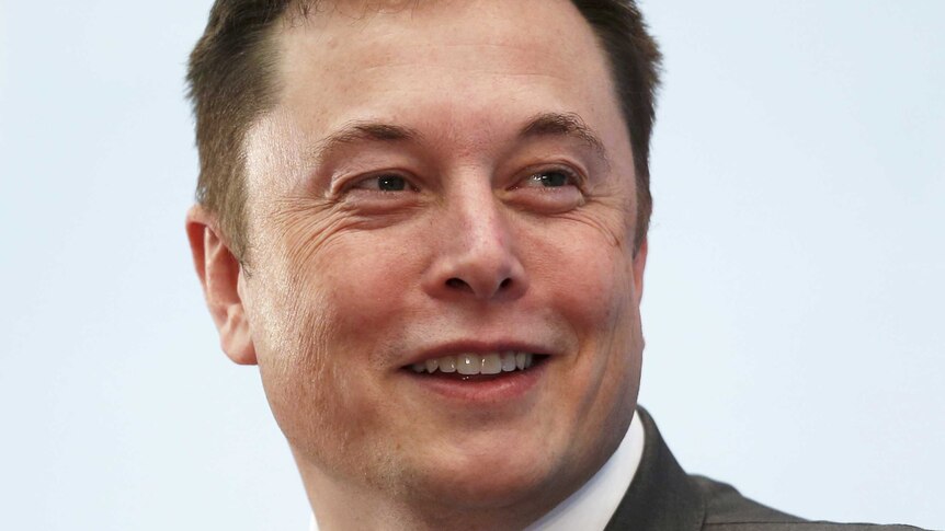 Elon Musk smiles as he attends a forum in Hong Kong