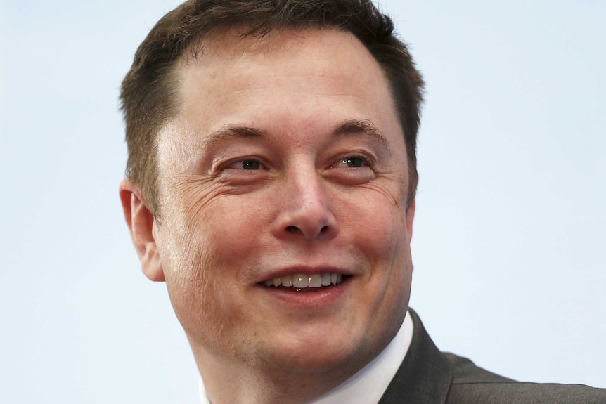 Elon Musk smiles as he attends a forum in Hong Kong