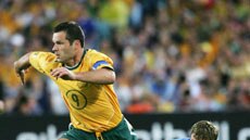 Socceroos captain Mark Viduka attempts to make a break