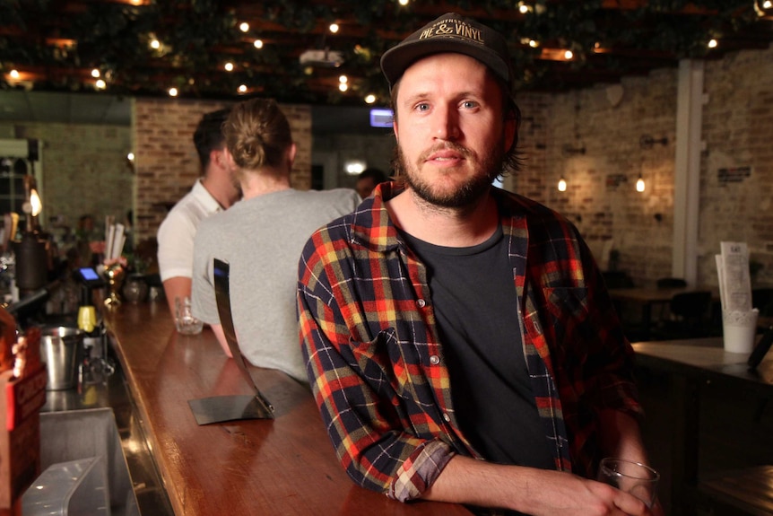 A man in a pub looking at the camera.