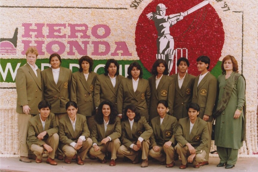 Pakistan players wear their khaki blazers and trousers and stand in a group for a promo photo