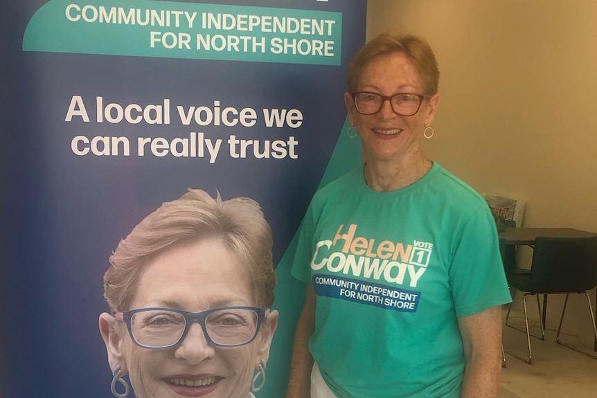 An older woman in a teal shirt.