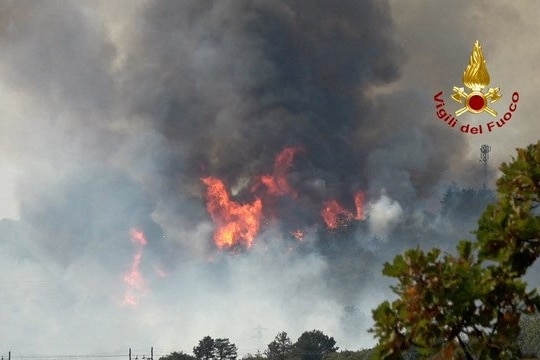 Dark plumes of smoke with flames in the middle. 