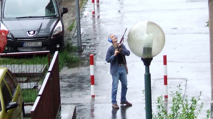 Slovakian gunman stands on street