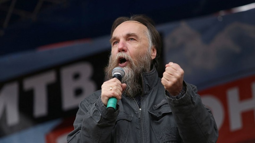 Russian politologist Alexander Dugin gestures as he addresses a rally