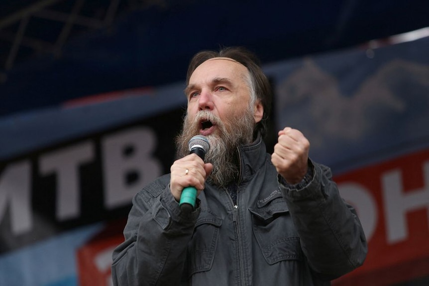 Russian politologist Alexander Dugin gestures as he addresses a rally.