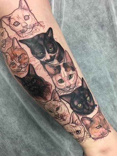 10 cat faces tattooed onto someone's leg.