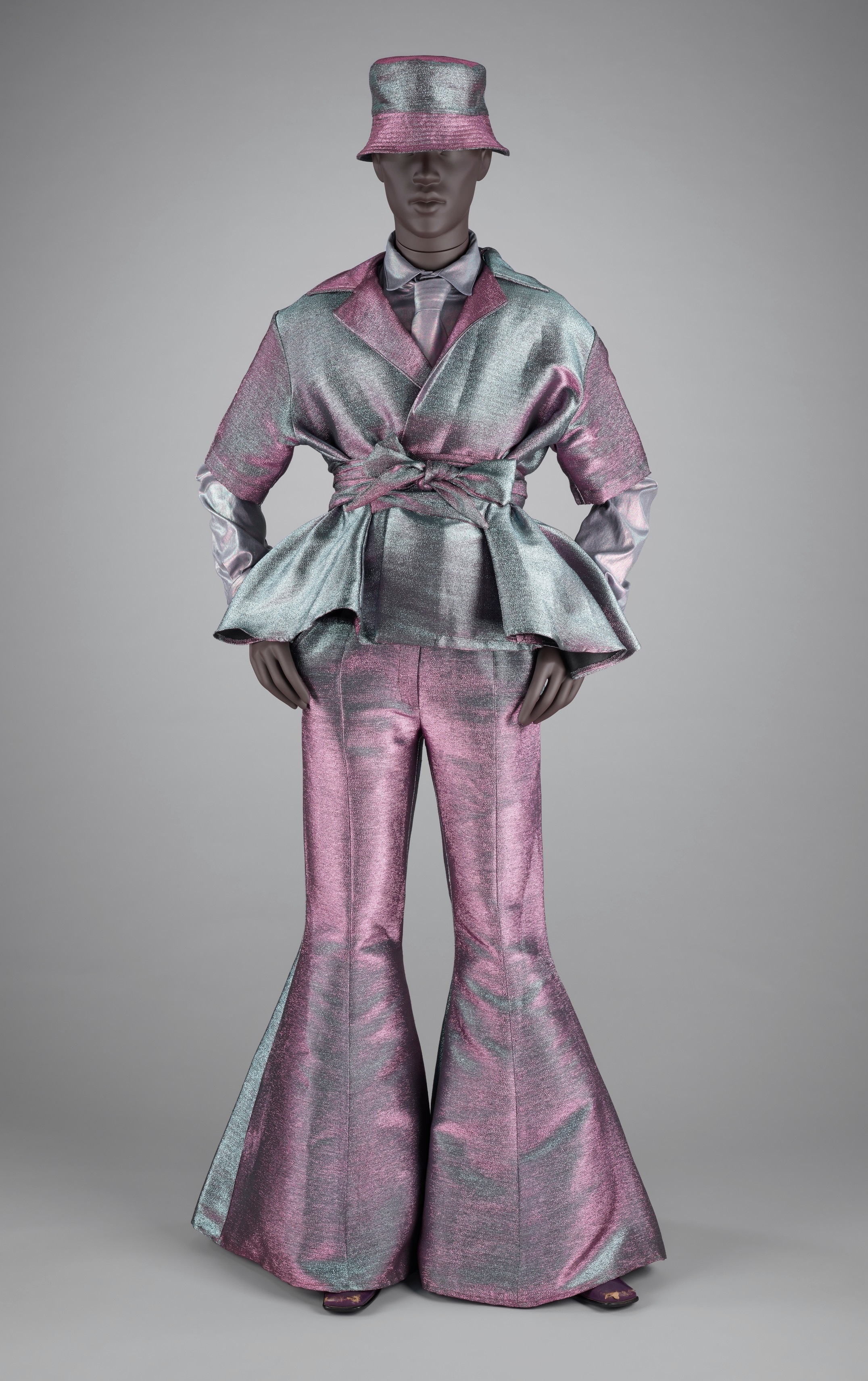 Iridescent pink, blue and silver peplum suit set on a mannequin with bell-bottomed pants