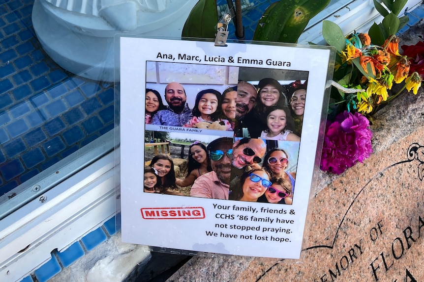 A shrine with a missing person poster with pictures of the the Guara family, Marc and Ana and their children Lucia and Emma.