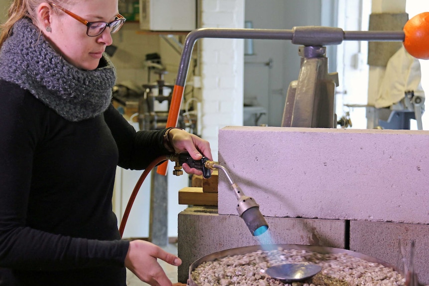 ACT silversmith Alison Jackson heating copper in studio