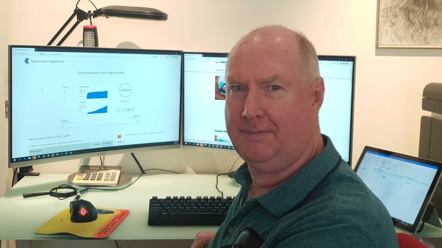 Ray Shaw sitting at his desk in front of his computer