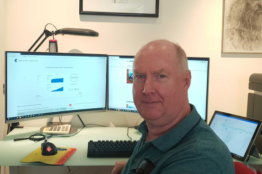 Ray Shaw sitting at his desk in front of his computer