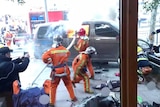 Firefighters put out a blaze after a minivan carrying gas tanks ploughed into pedestrians