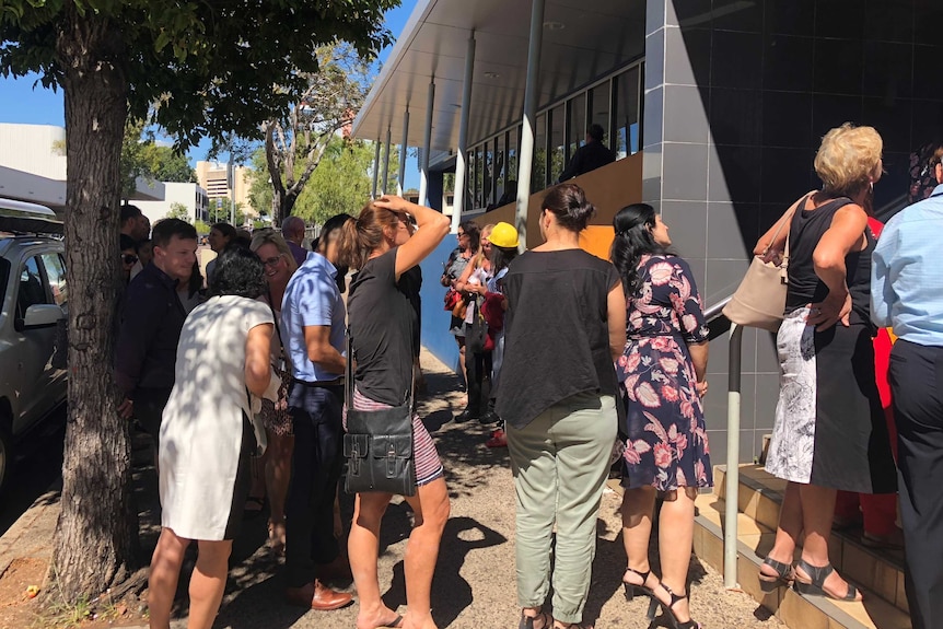 Evacuated employees outside Health House.