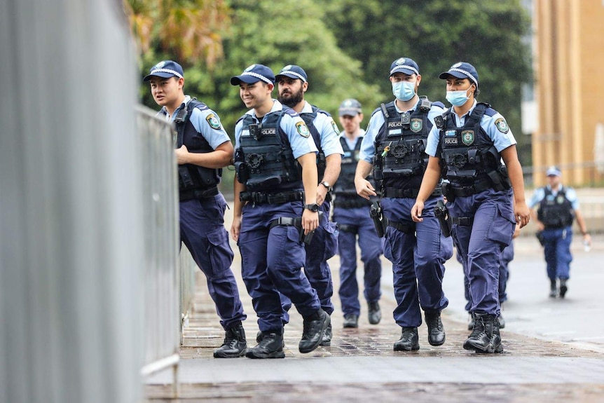 NSW police officers stand in a group for a briefing on New Year's Eve operations in Sydney.