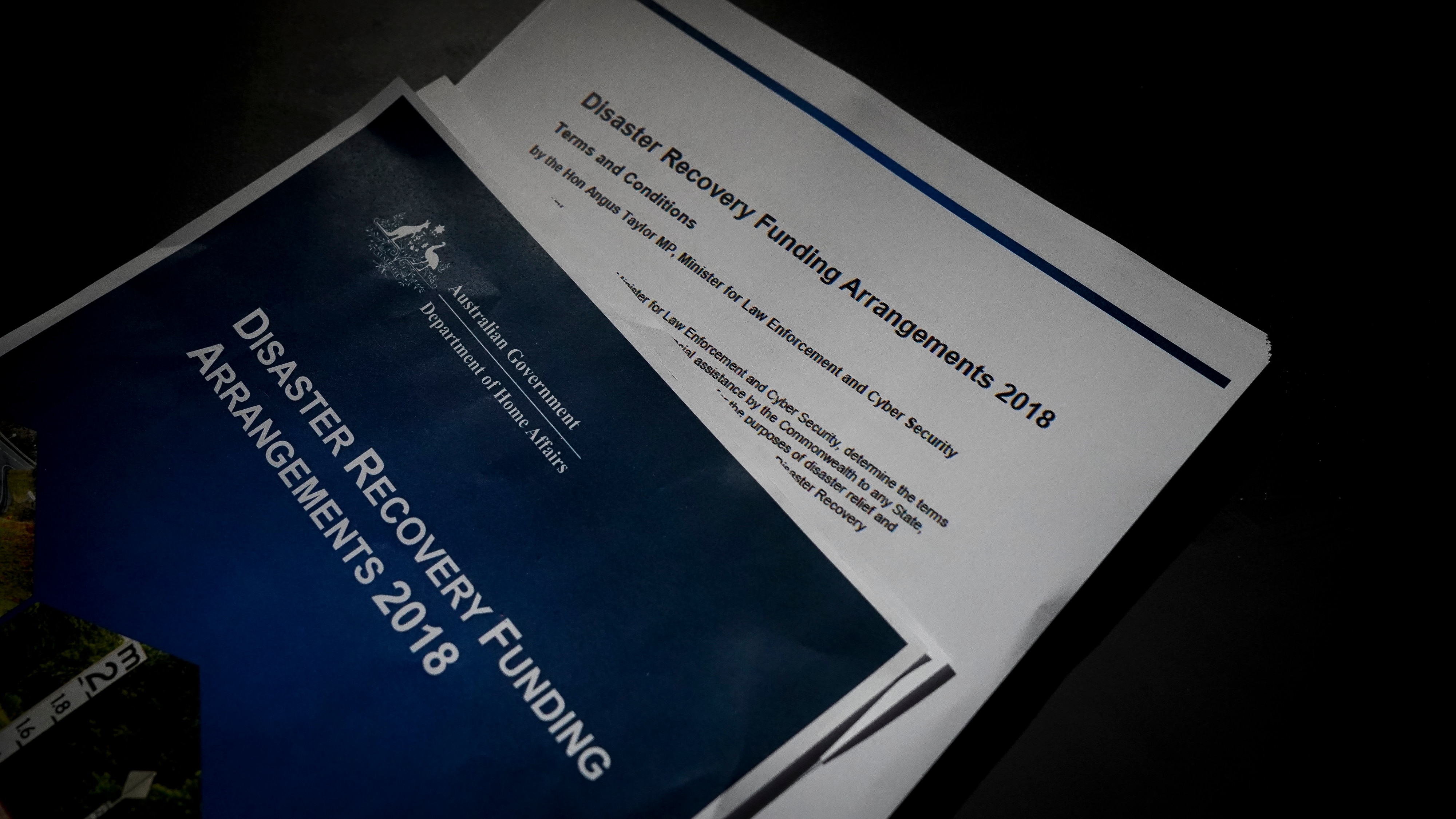 A paper report with a blue cover.