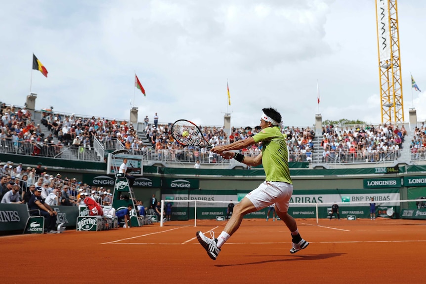 Kei Nishikori hits a shot at French Open
