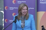 Premier Palaszczuk smiling at the lecturn.
