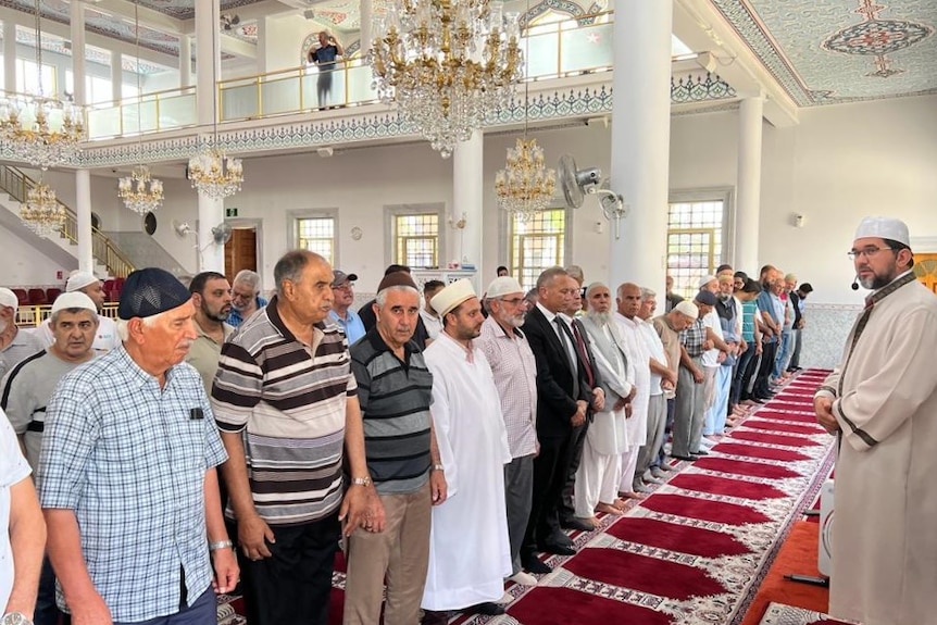 A group of men standing at a mosque