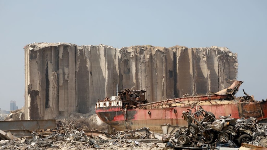 a wrecked cargo ship sits in the rubble of the Beirut blast of 4th August