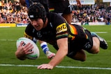 Penrith Panthers' Matt Burton dives over the tryline to score against the Canterbury Bulldogs.