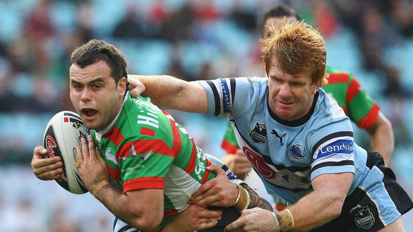 Souths pivot Ben Rogers is tackled by Lance Thompson of the Sharks