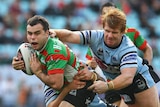 Souths pivot Ben Rogers is tackled by Lance Thompson of the Sharks