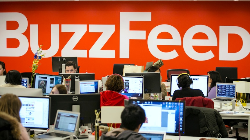 People in an office, typing on computers in a BuzzFeed office.
